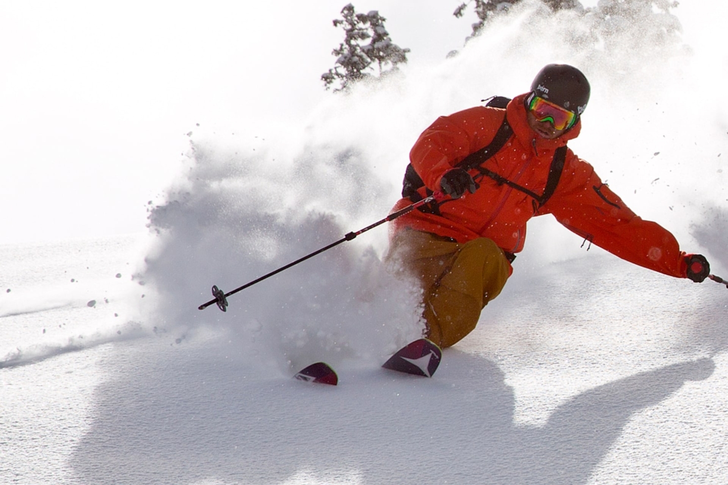 Skier skiing downhill through powdery snow